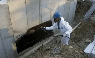 Professional waterproofing the exterior walls of the basement in Philadelphia, PA