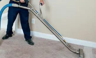Professional operating a liquid removal machine on a carpeted floor in Philadelphia, PA